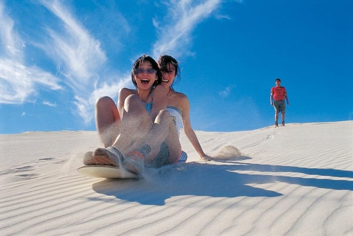 Sandboarding down the gentle slopes is a must for thrill-seekers